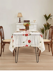 Detail of Christmas poinsettia floral embroidery on beige lace tablecloth
