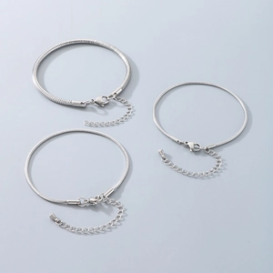 Macro shot of silver stainless steel snake bone chain bracelets with lobster clasps