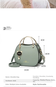 Detailed view of green cat shell bag with dimensions 23cm by 18cm and gold handles