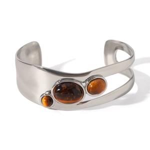 Macro detail of silver open bangle featuring three natural brown tiger eye stones