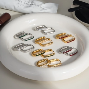 Elegant U-shaped gold and silver hoop earrings with inlaid pearls and gemstones