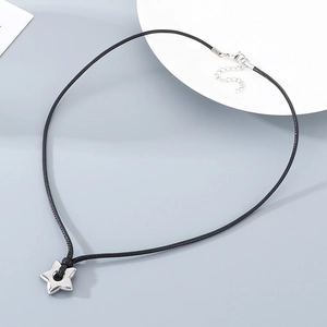 Detail of nylon rope necklace featuring a hollow star pendant and silver lobster clasp
