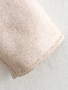 Macro shot of high-quality beige faux suede fabric texture with warm fleece lining
