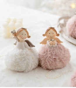 Detail of plush angel girl ornaments in pink and white with resin wings and ribbon
