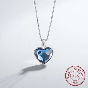Detail of S925 sterling silver heart necklace featuring a deep blue faceted crystal stone