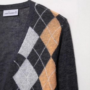 Women's dark grey argyle knit cardigan with white and orange geometric pattern sweater