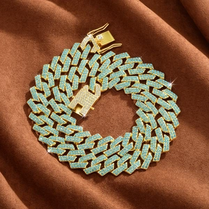 Macro detail of iced-out Cuban link chain with gold plating and blue rhinestones