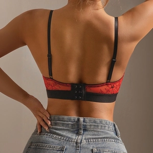 Close-up of red floral lace bra back with black elastic band and adjustable straps