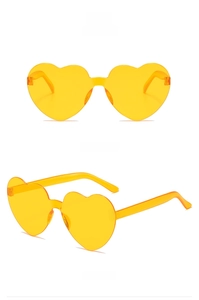 Detail view of yellow heart-shaped rimless sunglasses from front and side angles