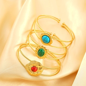 Gold plated titanium steel wire cuff bracelets featuring blue, green, and red stones
