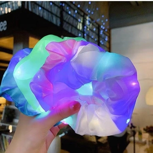Macro shot of colorful LED glowing scrunchies in blue, green, and pink colors