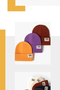Détails de bonnets en maille côtelée avec écussons lettrés en diverses couleurs