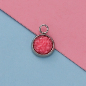 Detail shot of a 12mm pink druzy resin pendant set in a stainless steel round base