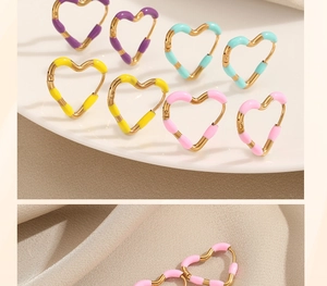 Close-up of colorful heart-shaped hoop earrings with vibrant enamel inlay on gold steel