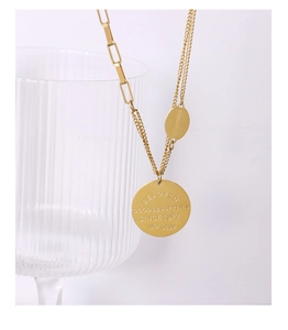 Detail of 18K gold-plated double-layer necklace with engraved round pendant on glass