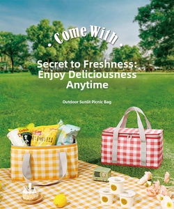 Detail of insulated picnic baskets in yellow and red plaid patterns on green grass