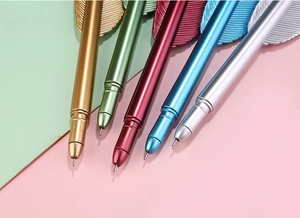 Close-up of multicolored vintage feather pens with metallic finish in five elegant shades