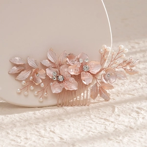 Detail of rose gold bridal hair comb with pearls, crystals and alloy floral leaf designs