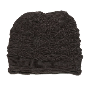Close-up of brown knit beanie showing wave-like texture and rolled edge details
