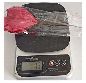 Detailed view of artificial Christmas flower weighing 13g with red glitter sequins