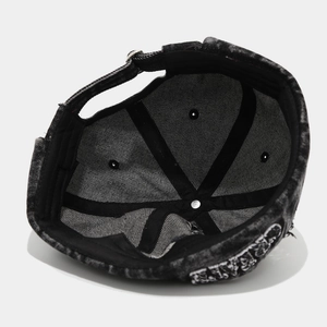Detailed interior of washed denim docker hat with reinforced stitching and metal buckle