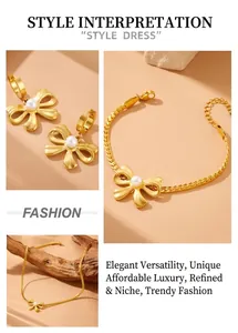 Close-up of gold stainless steel jewelry set with pearl bow pendants and flat snake chain
