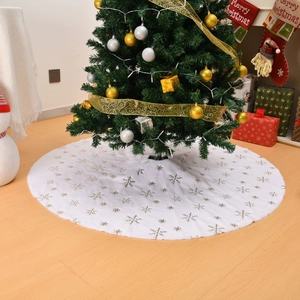 Plush white Christmas tree skirt with golden sequin snowflakes on wooden floor decor
