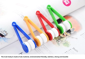 Portable V-shaped microfiber eyeglass cleaners in four colors on a magazine background