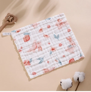 Detail shot of 100% cotton gauze baby washcloth showing soft texture and 30x30cm size label