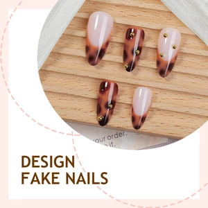 Faux ongles amande motif léopard avec perles dorées de luxe sur support en bois