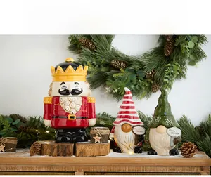 Festive Christmas ceramic set featuring Nutcracker King and Gnomes on a snow-covered base