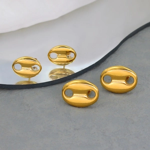 Macro shot of 18K gold plated coffee bean earrings with polished surface on stone