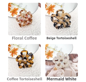 Close-up of hollow flower hair claws in acetate with rhinestones in four elegant colors