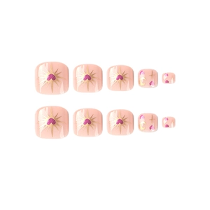 Pink press-on toe nails with purple hearts and gold celestial moon and star designs