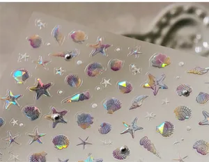 Macro shot of colorful laser shell and starfish nail stickers with holographic effect