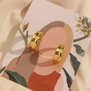 Chic 18K gold plated irregular wave C-shape hoop earrings on luxury champagne silk