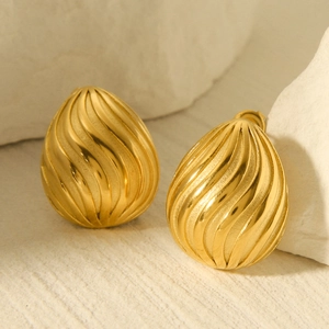 18k gold plated stainless steel teardrop earrings with spiral texture on stone surface