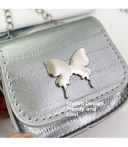 Detail of silver quilted saddle bag with metallic butterfly clasp and fine chain strap