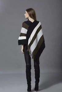Rear view of striped knit poncho with black, white, green patterns and tassel hem detail
