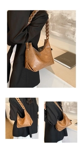 Detail of a brown leather hobo bag featuring a distinctive wide woven chain shoulder strap