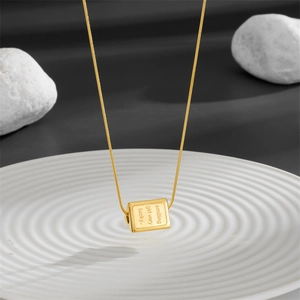 Gold triangular prism smile necklace with engraved slogan on polished snake chain