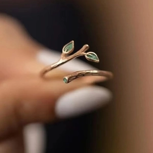Rose gold adjustable twig ring with green enamel leaves and a small sparkling diamond