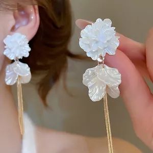 Elegant white acrylic flower earrings with long gold tassel fringe for women