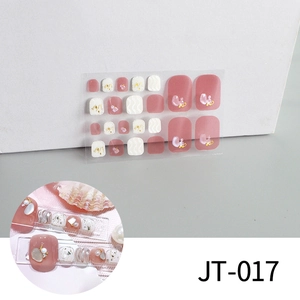 Detail of 3D rose pink and pearl white toe nail stickers with gold foil and rhinestones