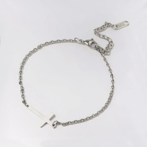 Polished silver stainless steel cross bracelet with adjustable link chain on white background
