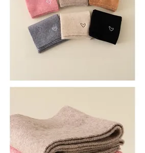 Detailed view of soft knit scarves for kids featuring delicate heart embroidery patterns