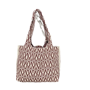 Knitted tote bag with red and white wave pattern in a spacious shoulder style design