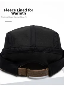Detail of warm black fleece lining and brown leather adjustment strap on retro beret cap
