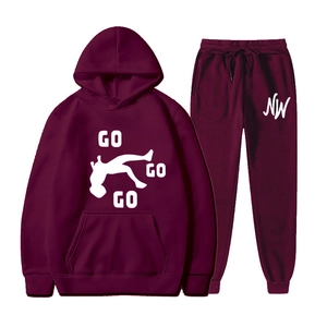Detail view of burgundy tracksuit with hoodie and joggers featuring GO GO GO print