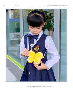 Detail of yellow silicone butterfly crossbody bag for kids with rainbow shoulder strap